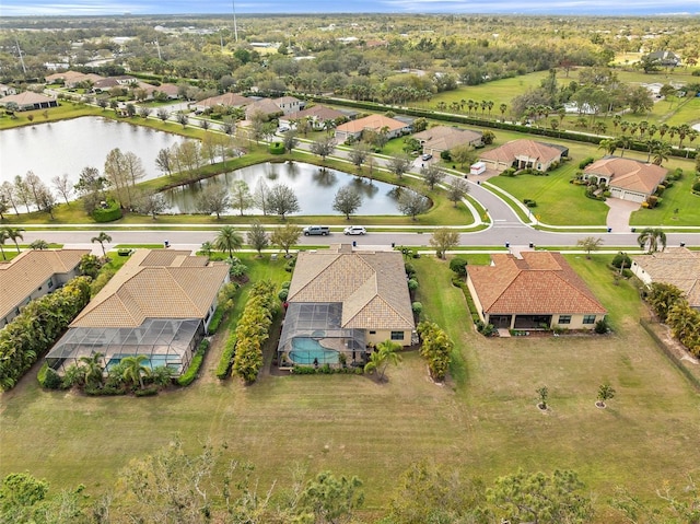 birds eye view of property with a water view and a residential view