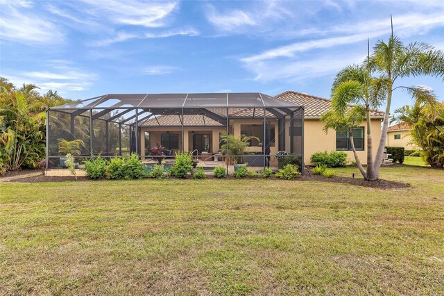 rear view of house featuring a tiled roof, a lawn, glass enclosure, and stucco siding