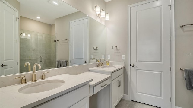 bathroom featuring double vanity, a sink, and a shower stall