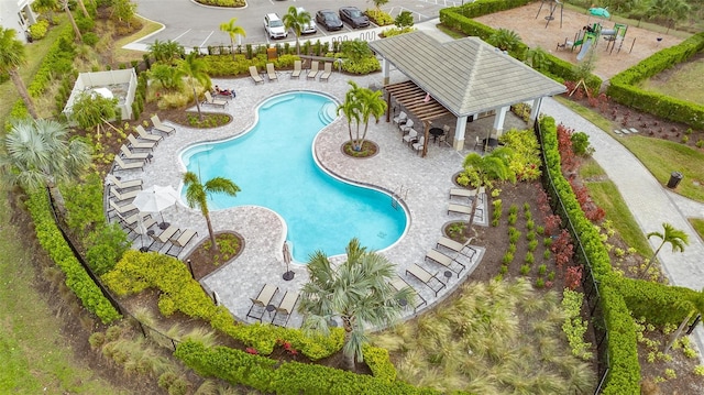 pool with a patio area and fence