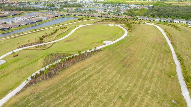 drone / aerial view featuring a residential view and a water view