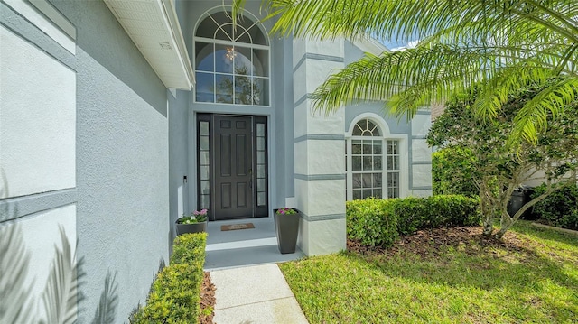 property entrance featuring stucco siding