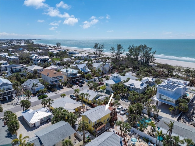 drone / aerial view with a beach view and a water view