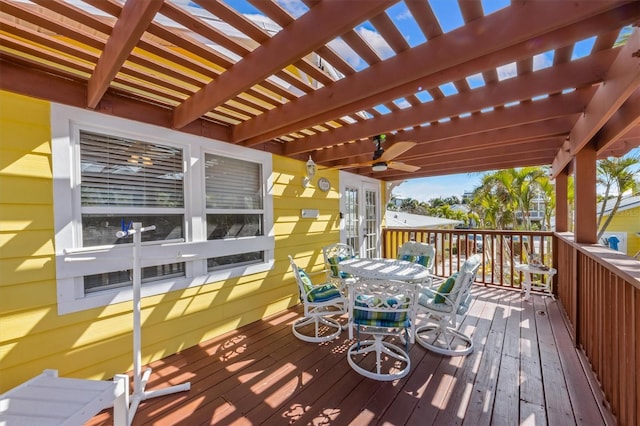 wooden deck featuring a pergola and outdoor dining space