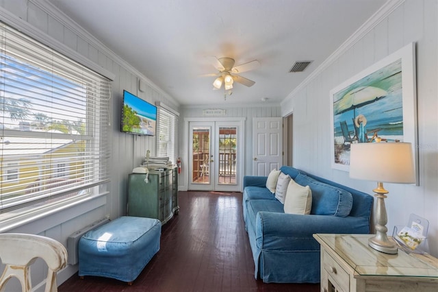 living area with ornamental molding, french doors, visible vents, and dark wood-type flooring