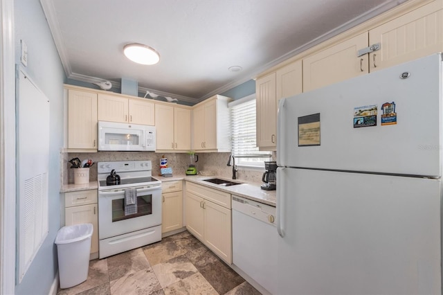 kitchen featuring white appliances, cream cabinetry, a sink, and light countertops