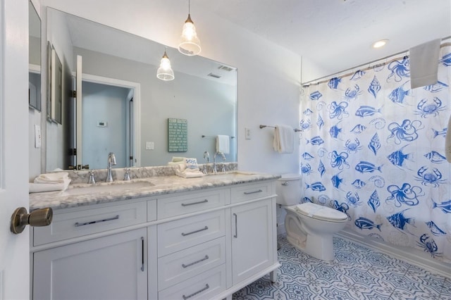 bathroom featuring toilet, tile patterned floors, shower / bath combo with shower curtain, and vanity