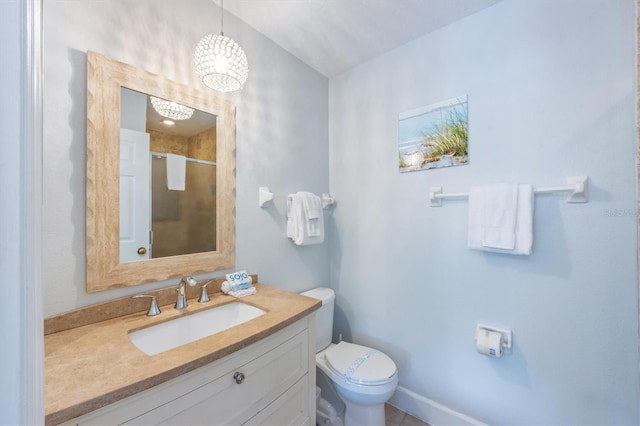 full bath with vanity, a shower stall, and toilet