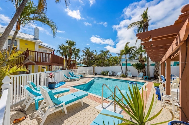 pool with a patio area and a fenced backyard