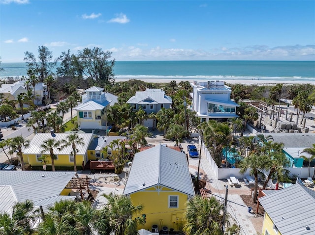 drone / aerial view featuring a beach view and a water view