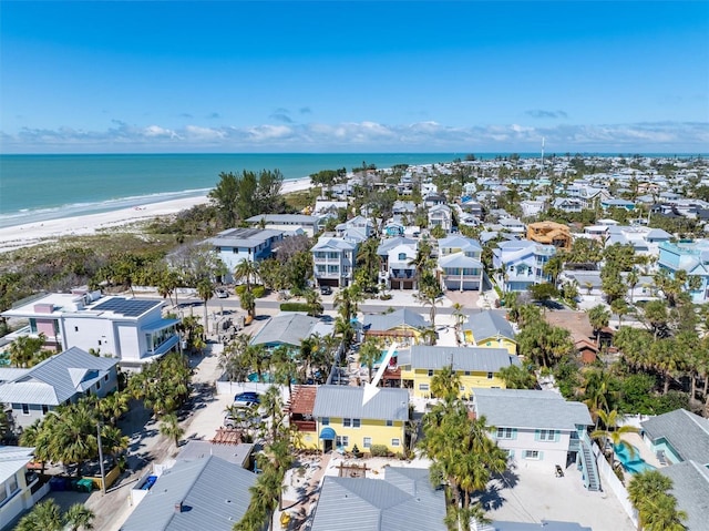 birds eye view of property featuring a water view, a residential view, and a beach view