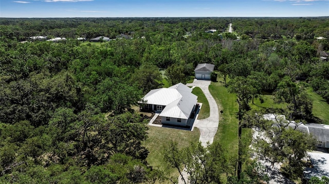 birds eye view of property featuring a wooded view