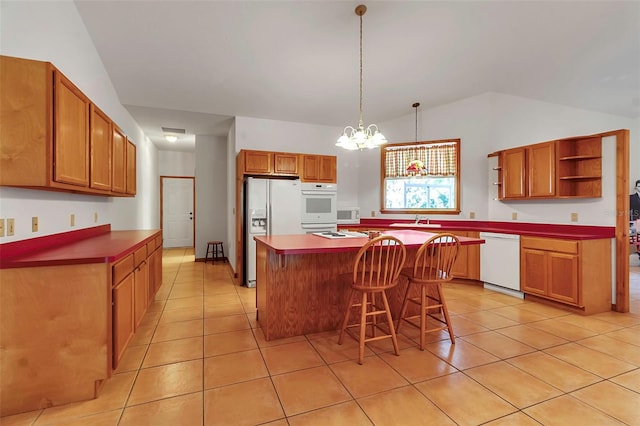 kitchen with a kitchen bar, open shelves, a sink, white appliances, and light tile patterned floors