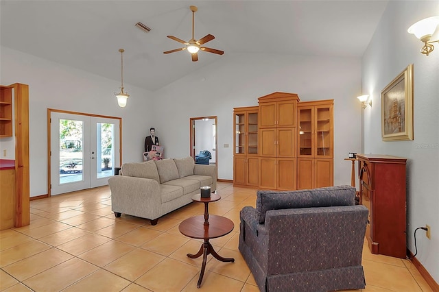 living room with light tile patterned floors, visible vents, high vaulted ceiling, and french doors