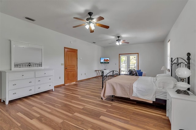 bedroom featuring visible vents, baseboards, light wood-style floors, and a ceiling fan