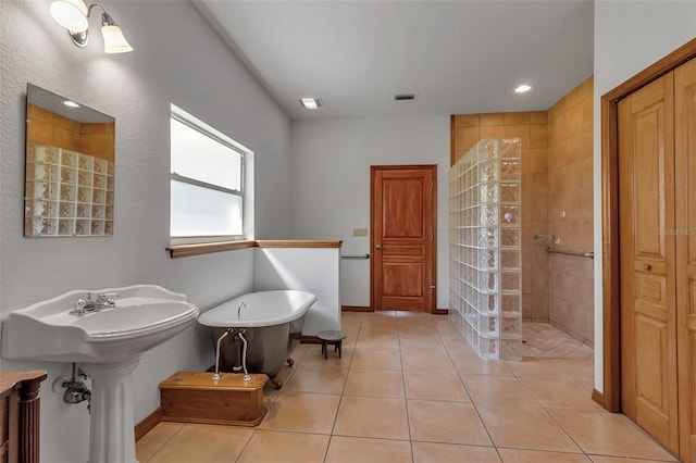 full bath featuring tile patterned flooring, visible vents, baseboards, walk in shower, and a freestanding bath