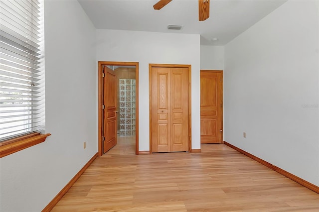 unfurnished bedroom featuring light wood-style floors, visible vents, and baseboards