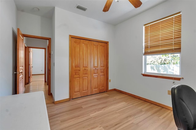 office area featuring baseboards, visible vents, and light wood-type flooring