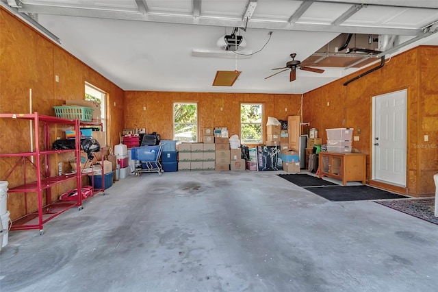 garage featuring wooden walls and a garage door opener