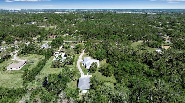 birds eye view of property featuring a forest view