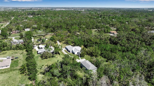 drone / aerial view with a wooded view