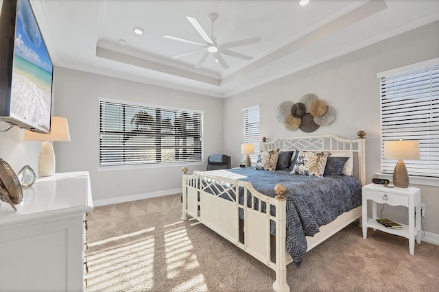 bedroom with light carpet, a tray ceiling, ornamental molding, and baseboards