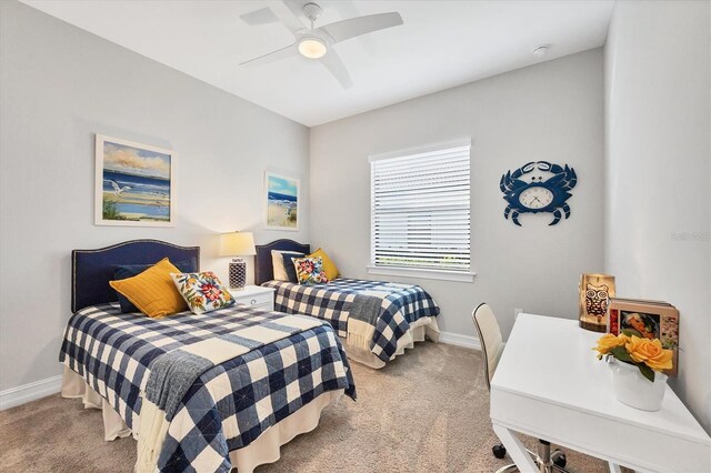 carpeted bedroom featuring a ceiling fan and baseboards