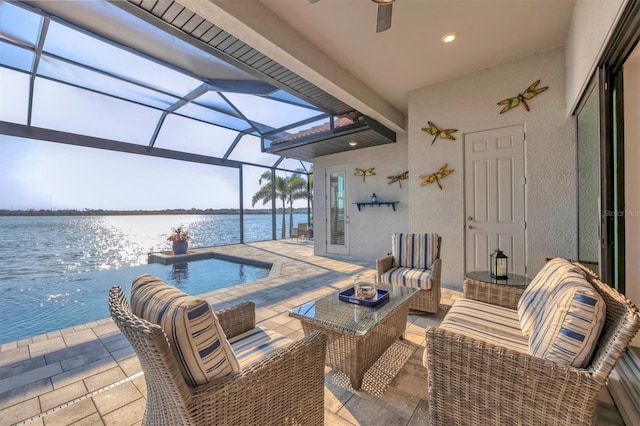 view of patio with a water view, a lanai, an outdoor pool, and an outdoor living space