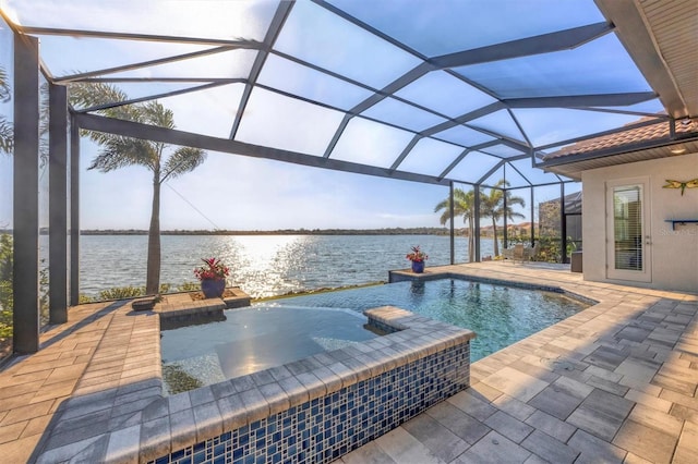 view of pool featuring a patio, a pool with connected hot tub, a water view, and glass enclosure