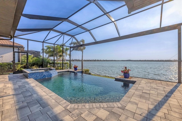 view of pool featuring a patio area, a lanai, a pool with connected hot tub, and a water view