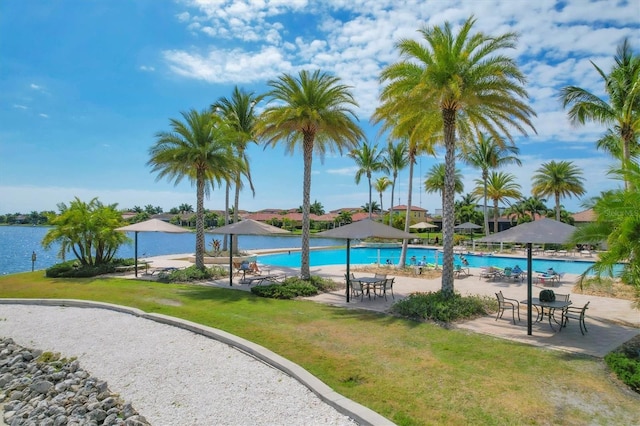 pool with a yard and a patio area