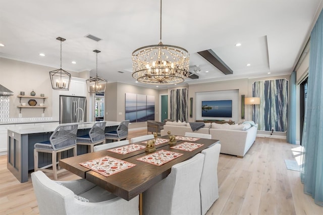 dining space with ornamental molding, light wood-type flooring, a notable chandelier, and recessed lighting