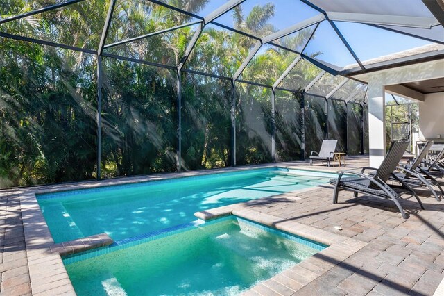 view of swimming pool with a patio area and a pool with connected hot tub