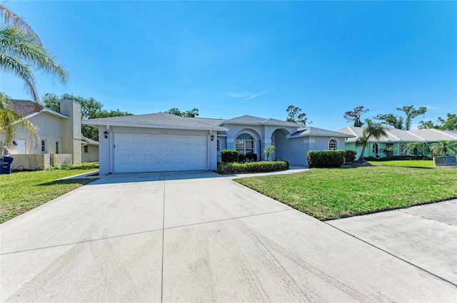 single story home featuring a garage, a front lawn, concrete driveway, and stucco siding