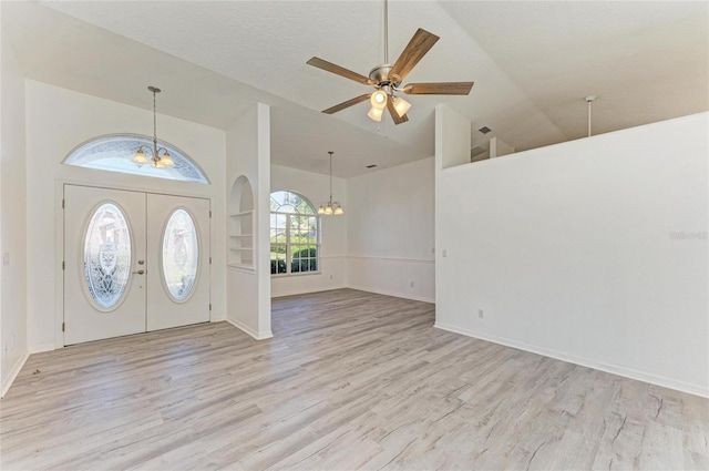 entryway with light wood-type flooring, baseboards, and ceiling fan with notable chandelier