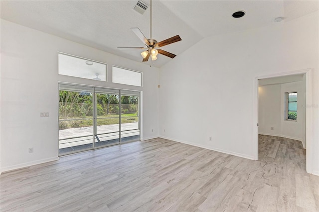 spare room with baseboards, ceiling fan, visible vents, and light wood-style floors