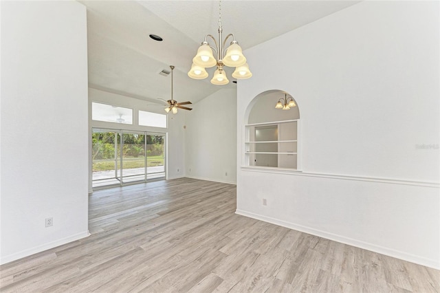 empty room with built in shelves, visible vents, baseboards, and wood finished floors