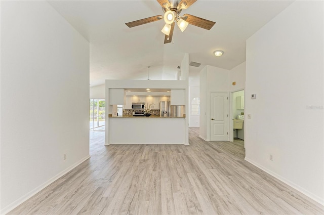 unfurnished living room featuring lofted ceiling, baseboards, ceiling fan, and light wood finished floors