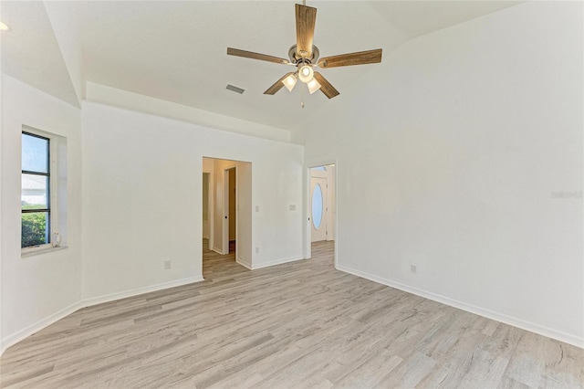 spare room featuring baseboards, ceiling fan, visible vents, and light wood-style floors