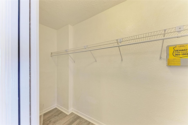 spacious closet with wood finished floors