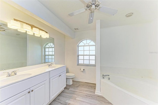 full bathroom featuring visible vents, a sink, toilet, and wood finished floors