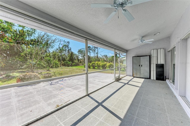 unfurnished sunroom featuring vaulted ceiling and ceiling fan