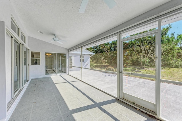 unfurnished sunroom featuring plenty of natural light, lofted ceiling, and ceiling fan