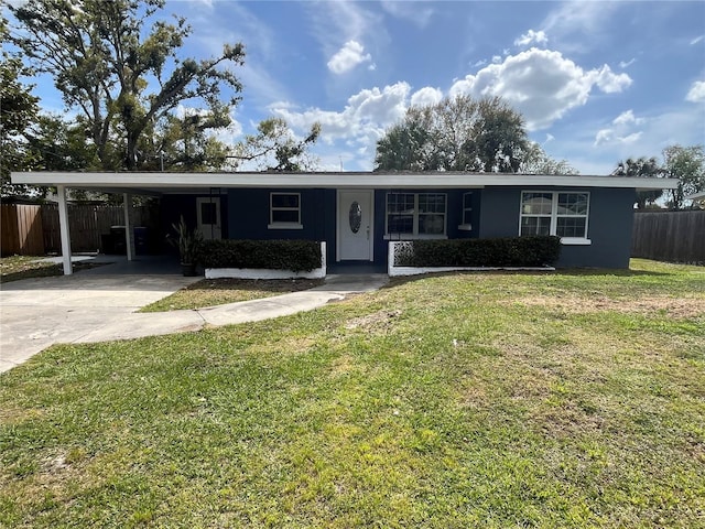 ranch-style home with a carport, concrete driveway, a front lawn, and fence