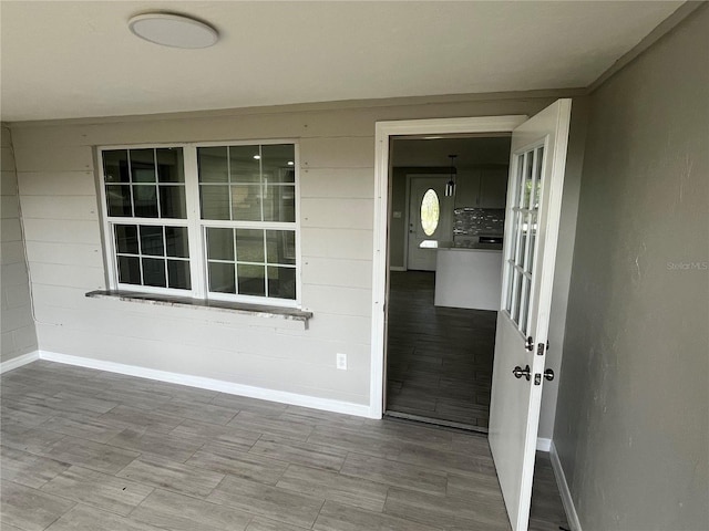 interior space featuring wood finished floors and baseboards