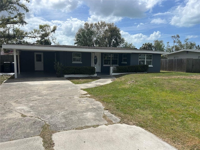 single story home featuring a carport, driveway, a front lawn, and fence