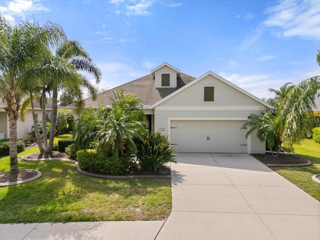 view of front facade with an attached garage, a front lawn, concrete driveway, and roof with shingles