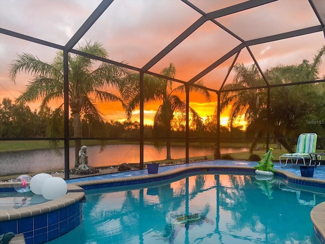 pool at dusk with a patio, a lanai, and an outdoor pool