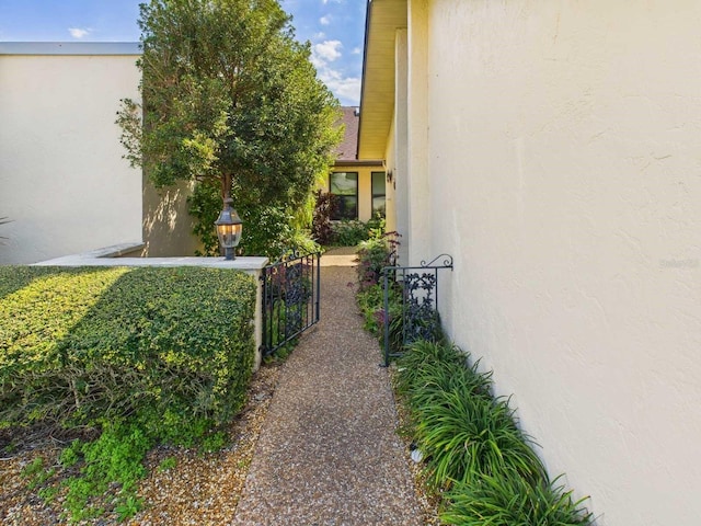 view of property exterior featuring a gate and stucco siding