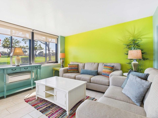 living room featuring an accent wall and light tile patterned flooring